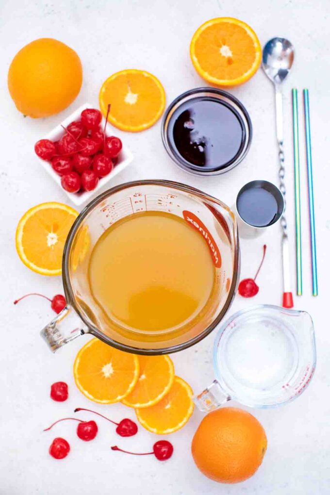 overhead shot of orange juice tequila grenadine in bowls on a table