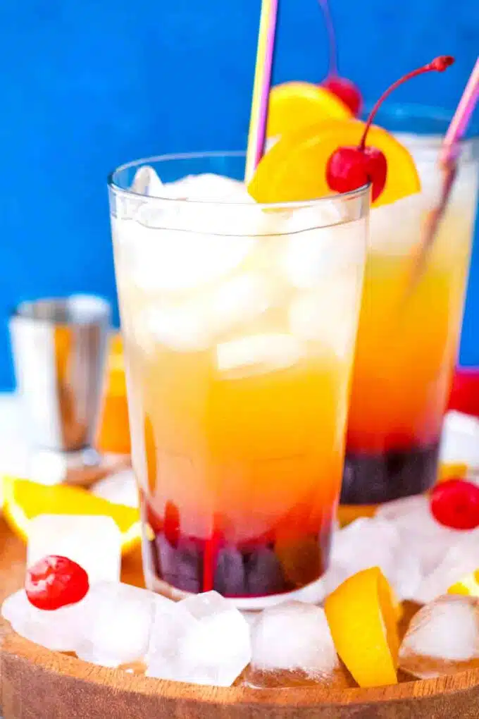 tequila sunrise cocktail on a platter filled with ice