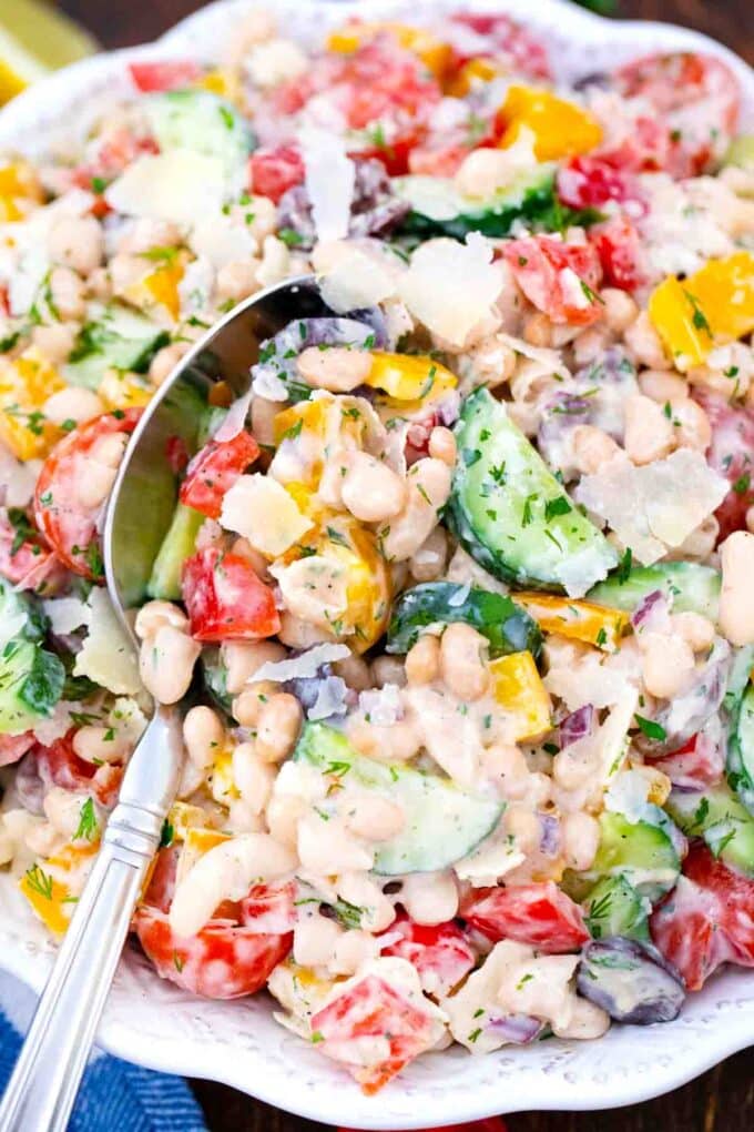 overhead shot of crunchy bean salad with a serving spoon
