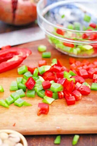 chopping green and red bell peppers