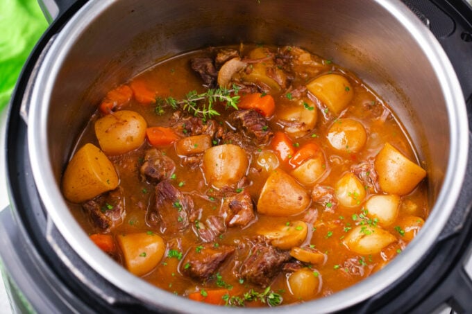 Instant Pot beef stew with potatoes, carrots, and mushrooms.