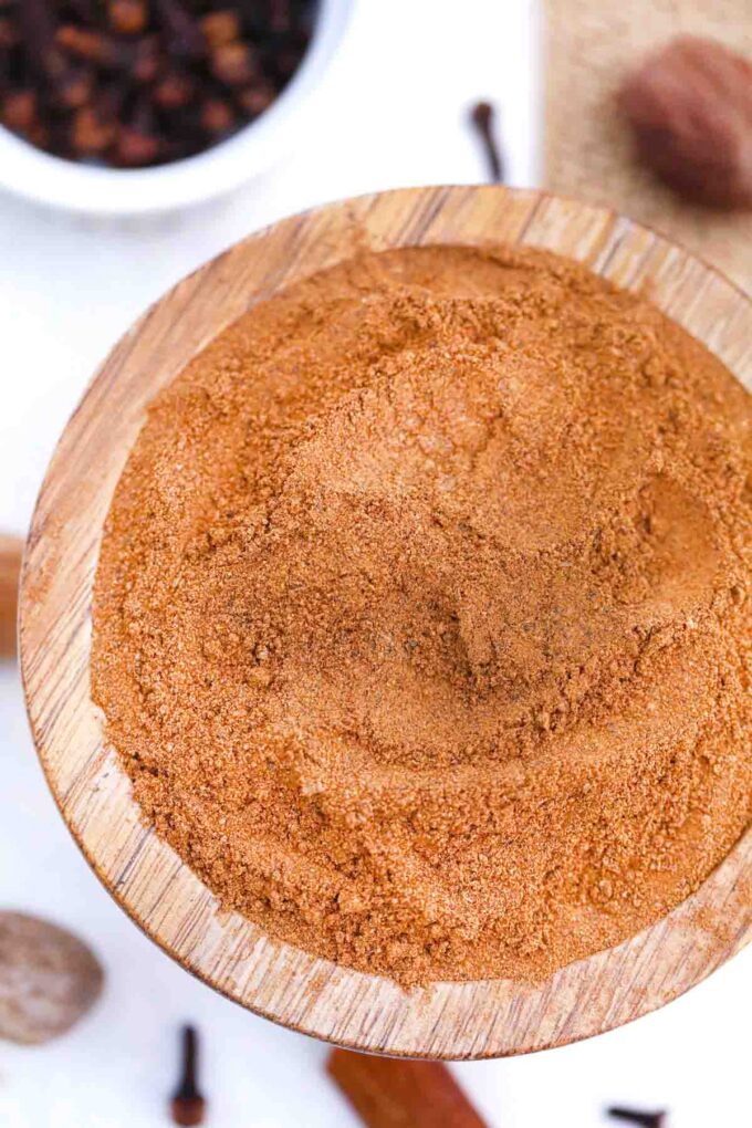 overhead shot of homemade allspice substitute in a wooden bowl