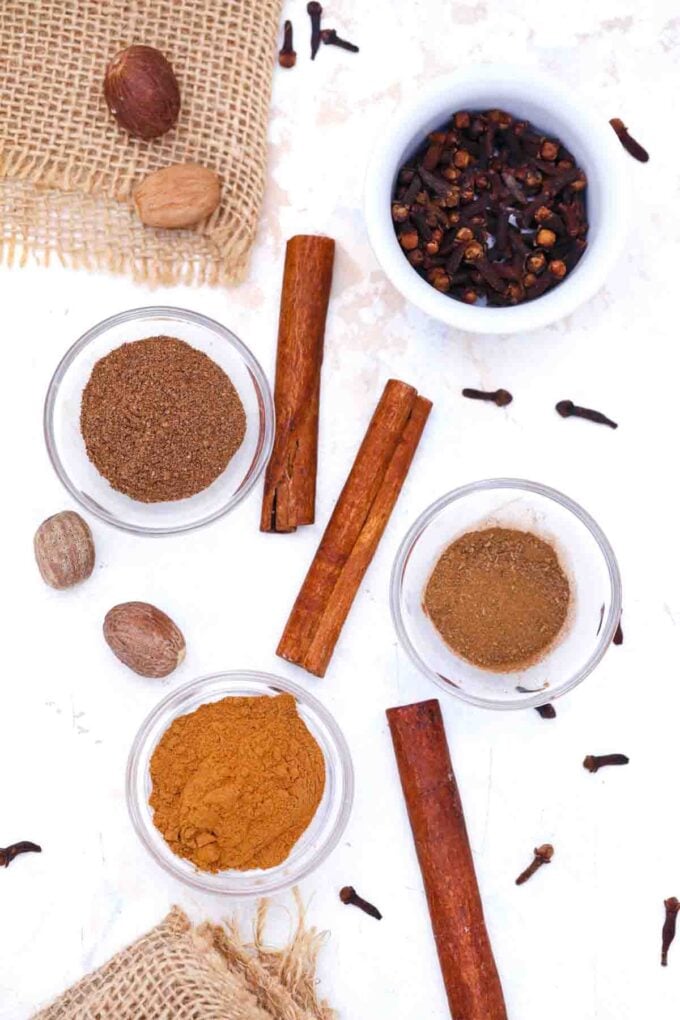 overhead shot of allspice substitute ingredients in bowls on a table