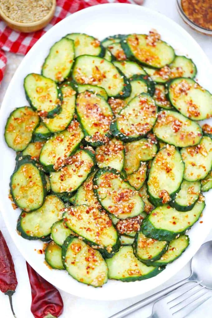 overhead shot of asian spicy cucumber salad on a serving plate