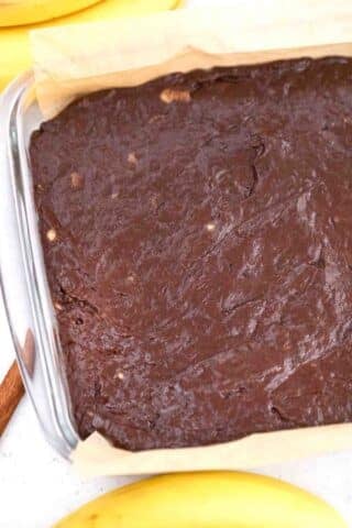 raw brownie batter in a pan before baking