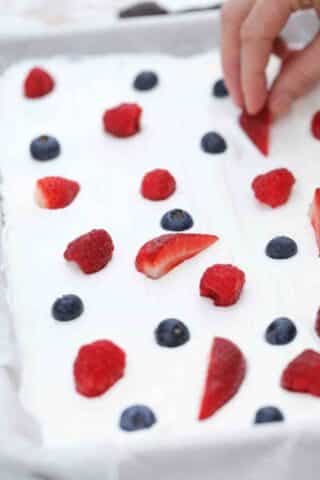 adding berries to greek yogurt bark