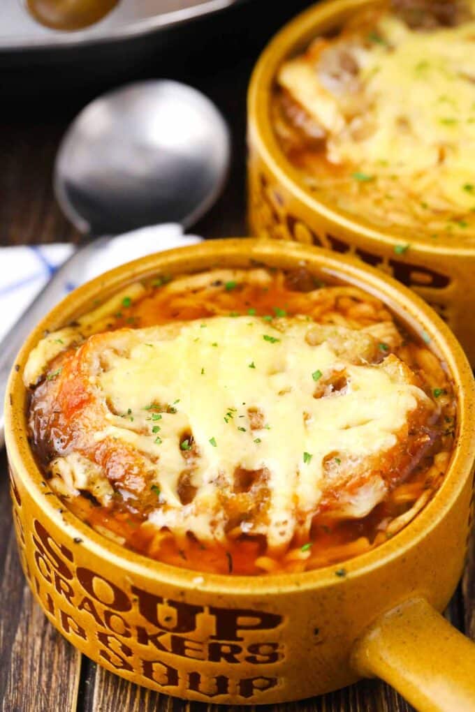 a bowl of instant pot french onion soup topped with a slice of french baguette and melted cheese