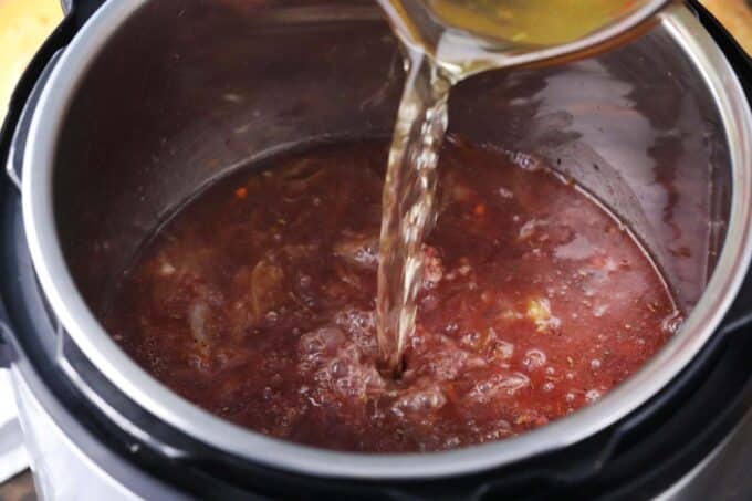 adding broth to instant pot french onion soup