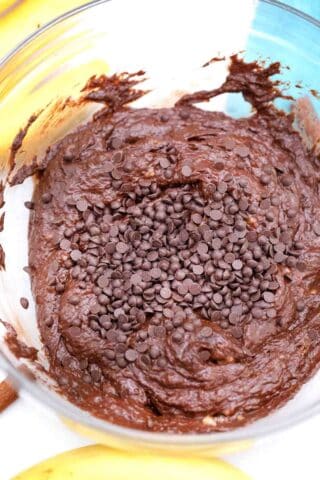 adding chocolate chips to brownie batter