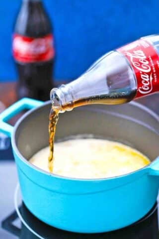 adding coco cola to a saucepan with butter