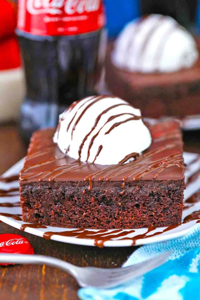 a slice of cracker barrel coca cola cake topped with ice cream