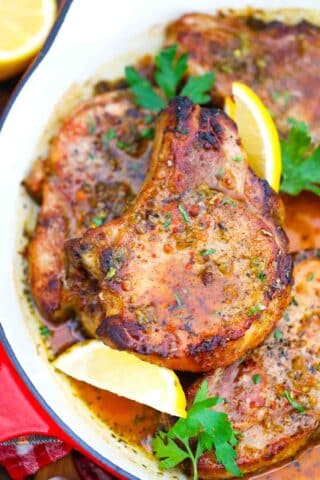 overhead shot of baked lemon pork chops in a cast iron pan