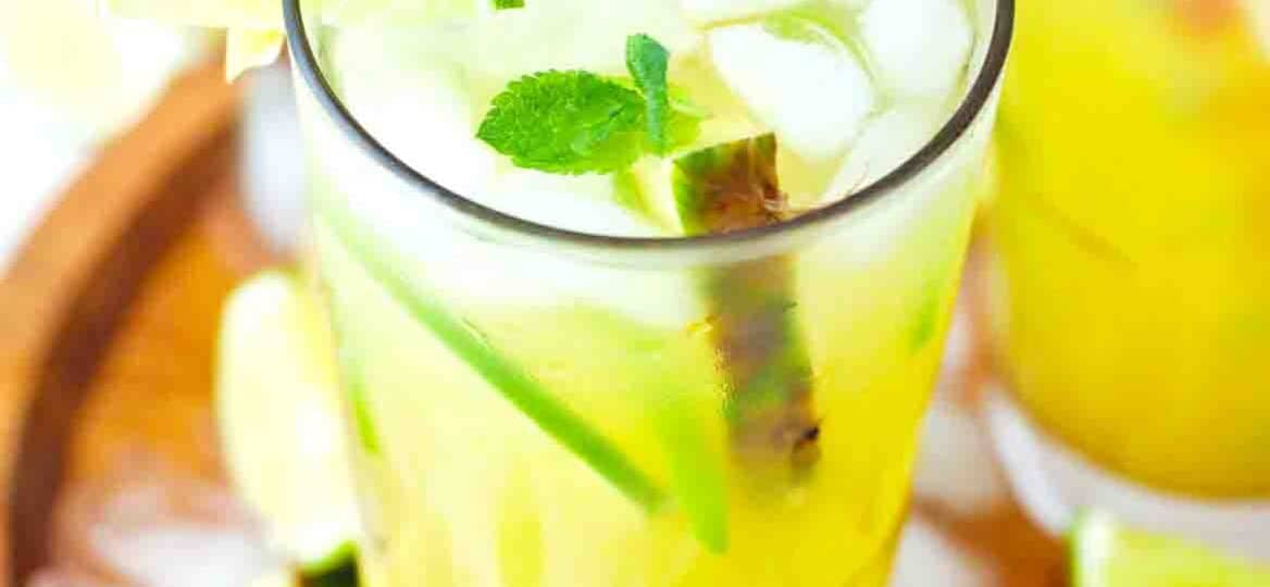 pineapple mojito on a wooden tray with ice cubes