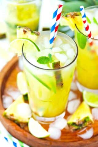 pineapple mojito on a wooden tray with ice cubes