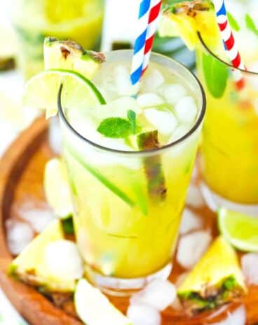 pineapple mojito on a wooden tray with ice cubes