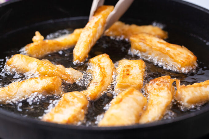 Frying beer-battered fish strips.
