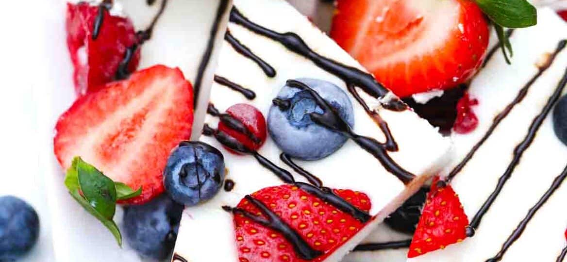 frozen yogurt bark topped with berries and chocolate drizzle