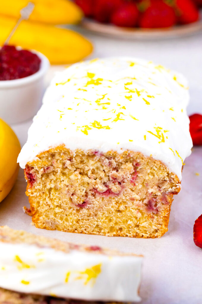 Strawberry banana bread topped with lemon glaze.