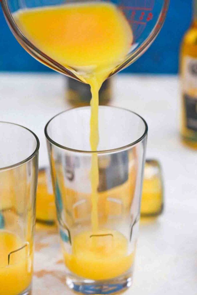 pouring orange juice into a glass