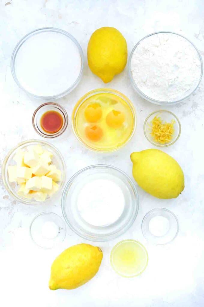 overhead shot of lemon ricotta cake ingredients in bowls on a table