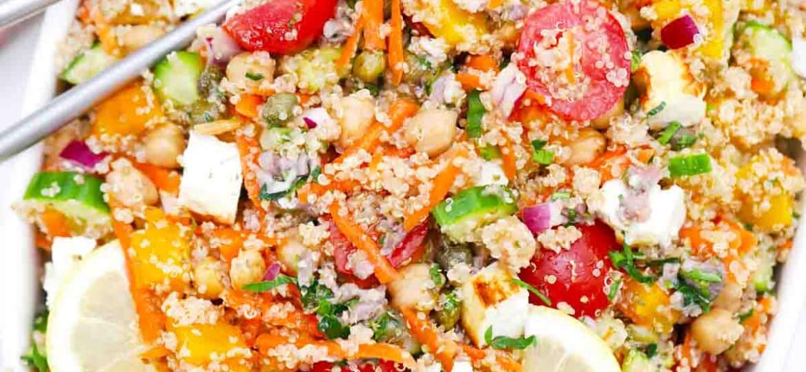 overhead shot of mediterranean grilled feta quinoa salad in a large serving bowl