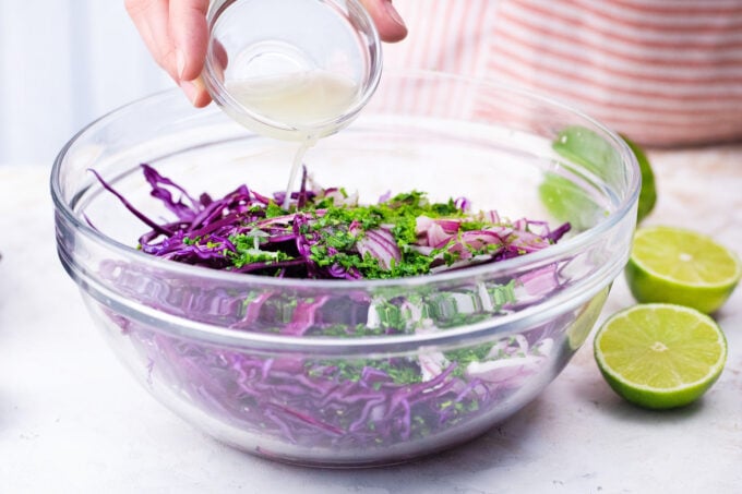 Mixing the ingredients for purple cabbage slaw.