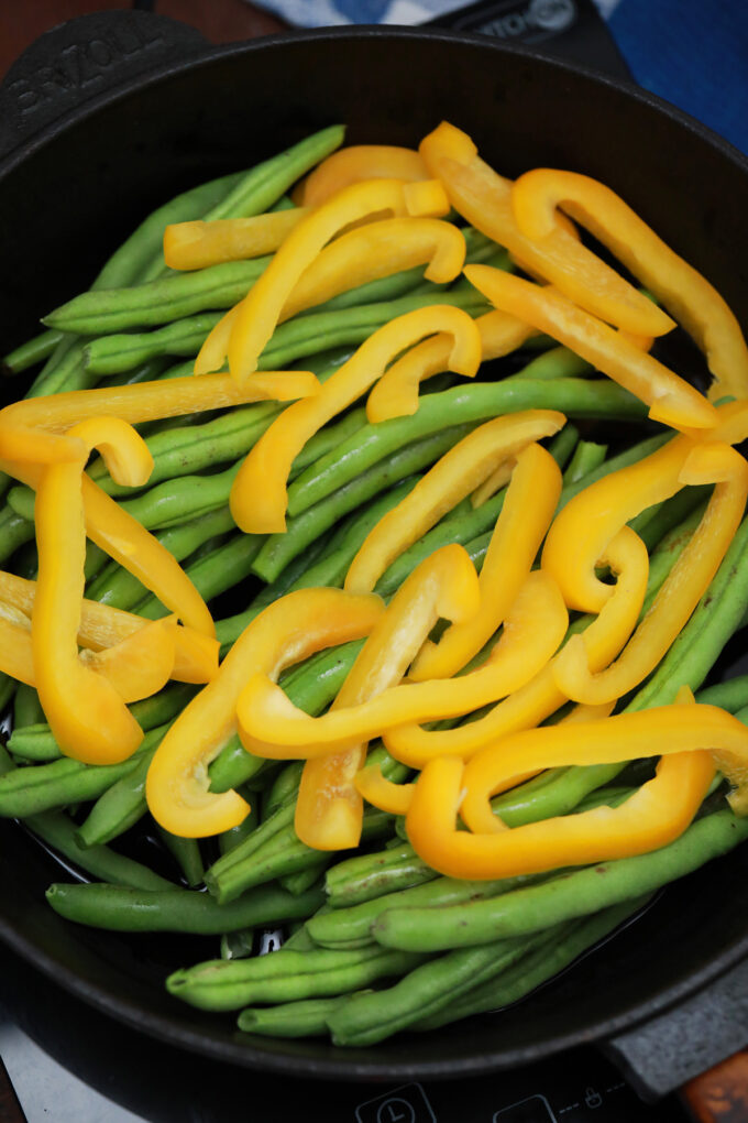 Sautéing sliced bell peppers and string beans.