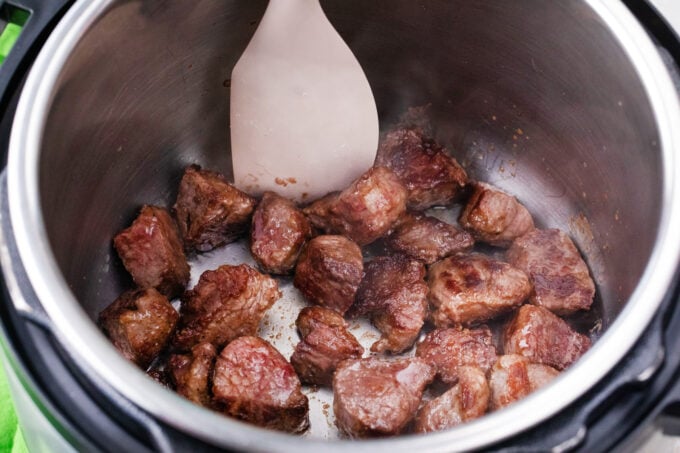 Searing beef pieces in the Instant Pot.