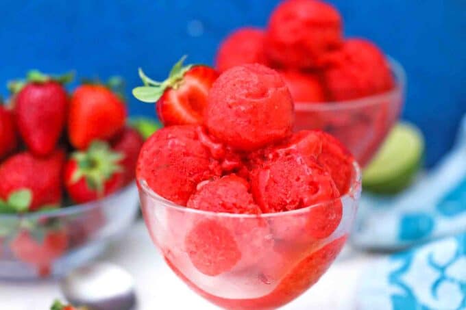 ice cream bowls filled with strawberry sorbet and served with fresh strawberries