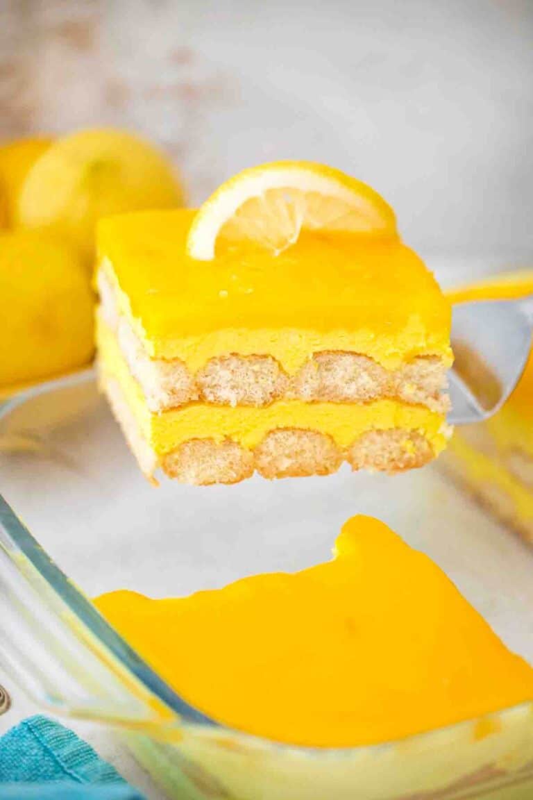 lifting a slice of limoncello tiramisu from the serving dish