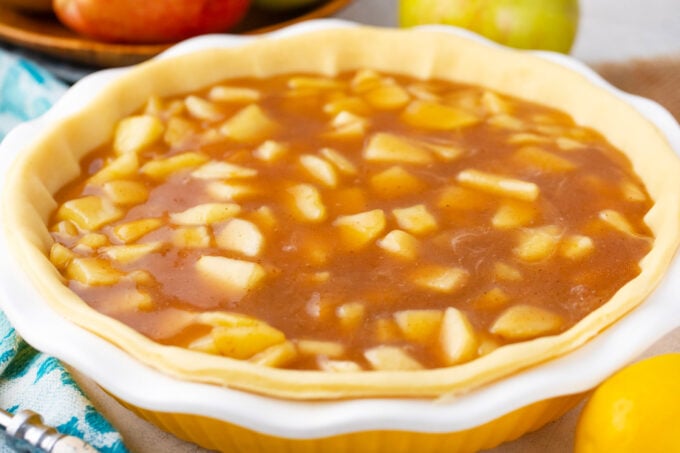 Homemade apple pie filling in a pie crust.