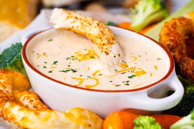 Dipping a pretzel in beer cheese dip.