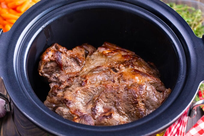 Seared chuck roast in the slow cooker.