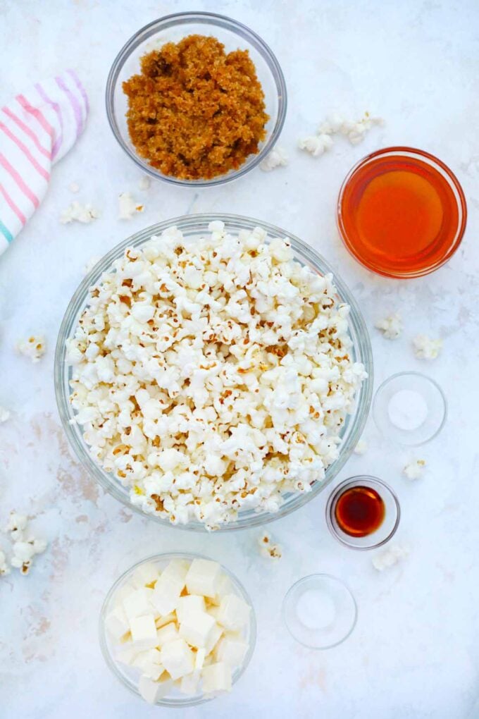 overhead shot of caramel popcorn ingredients arranged in bowls on a table