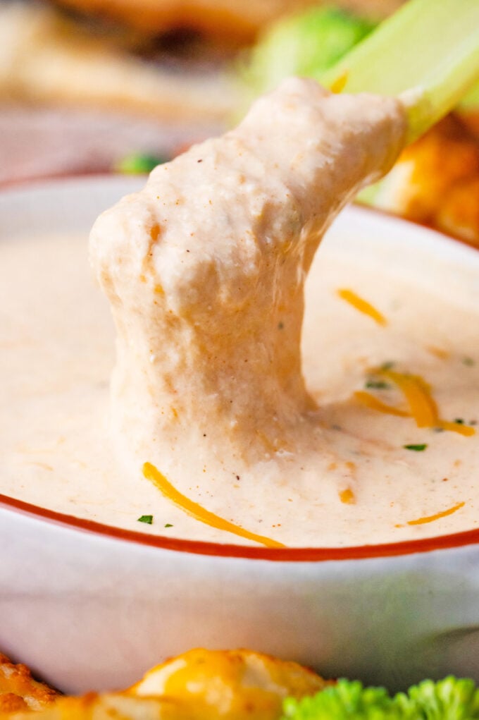 Dipping a celery stick into beer cheese dip.