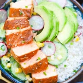 cucumber miso salmon rice bowls topped with avocado and radish