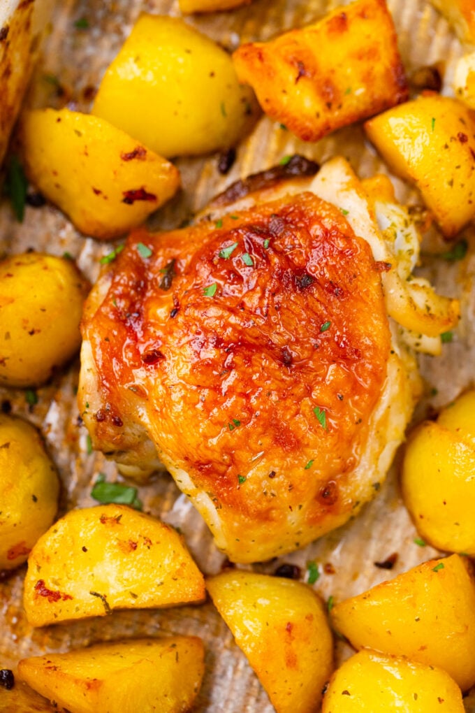 Crispy chicken and potatoes on a baking sheet.