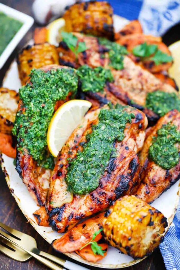 overhead shot of grilled chimichurri chicken served with corn