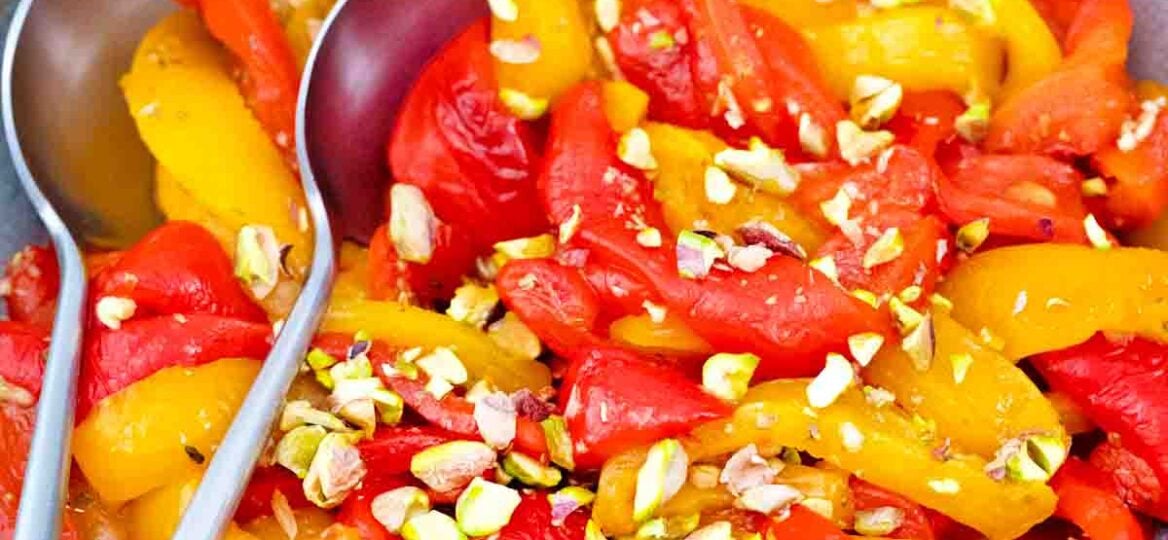 overhead shot of homemade roasted bell peppers with chopped pistachios