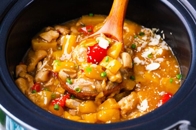 A ladle of slow cooker Hawaiian chicken.