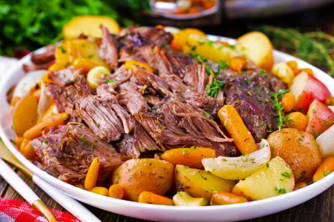 A platter of tender red wine slow cooker pot roast with root vegetables.