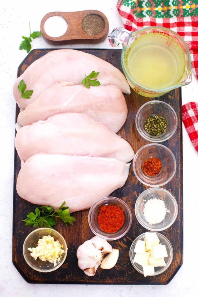 Overhead shot of instant pot shredded chicken ingredients on a wooden board.