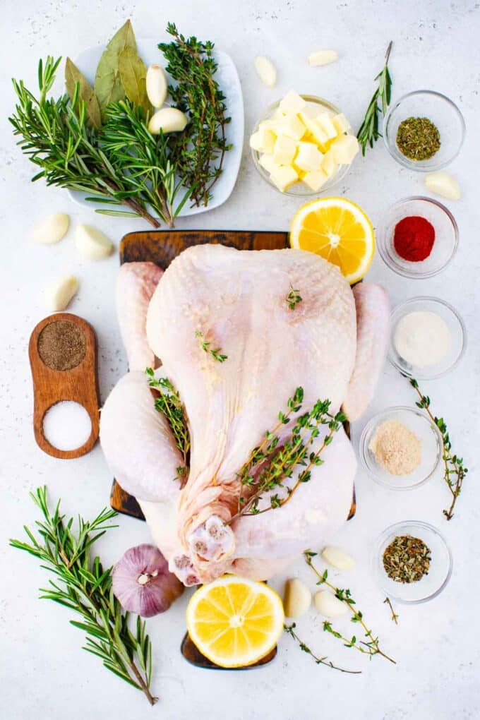 instant pot whole chicken ingredients on a cutting board and bowls on a table