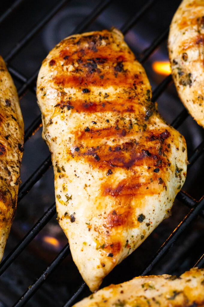 Grilled chicken breast on the grill.