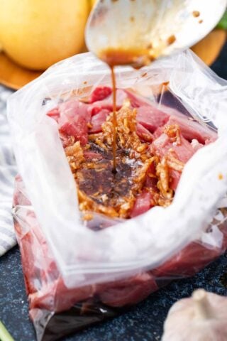 korean beef bulgogi marinade with the beeef slices in a ziplock bag