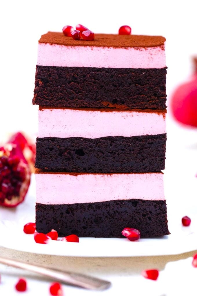 pomegranate mousse brownies stacked on top of each other