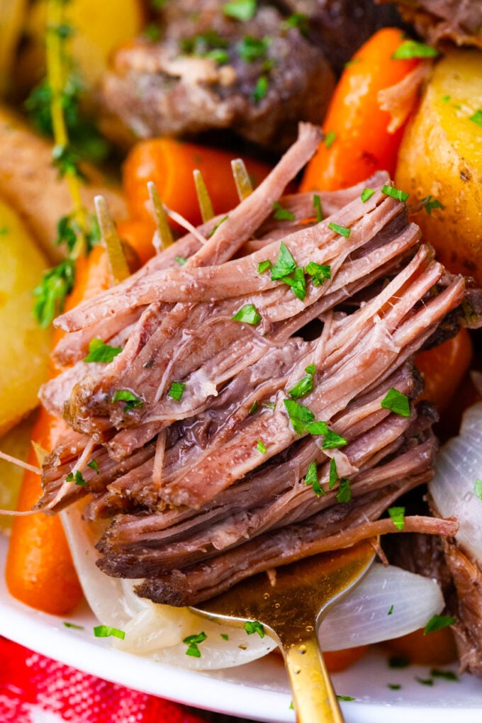 Very tender red wine slow cooker pot roast.