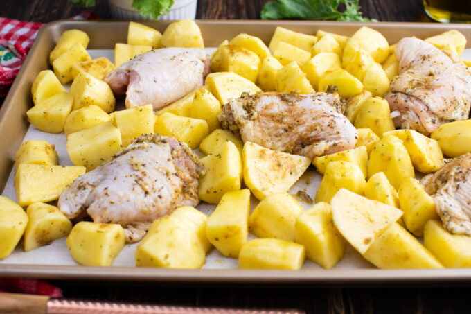 Ranch chicken and potatoes on a baking sheet.