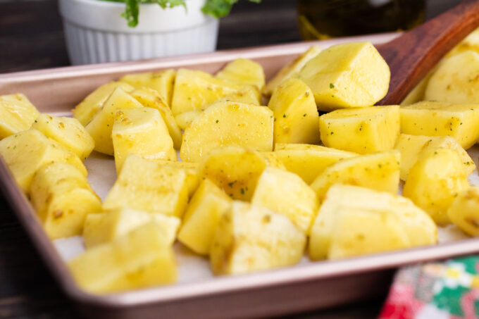 Potato chunks on a baking sheet.