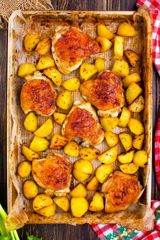 Overhead shot of crispy Ranch chicken and potatoes on a baking sheet.